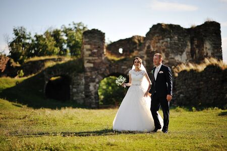 wedding couple on the ruins of the old castleの写真素材