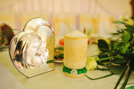 Image of holy family and candle on wedding tableの写真素材