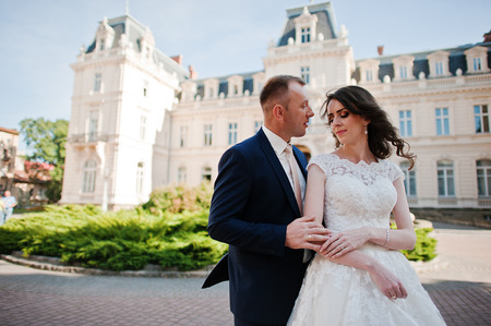 wedding couple on background of great historical palaceの写真素材