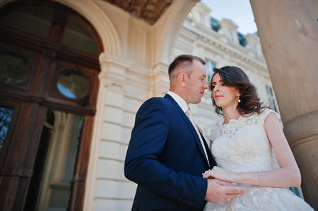 wedding couple on background of great historical palaceの写真素材