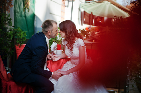 Just married sitting on red table at coffeehouseの写真素材