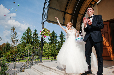 Holding hands of wedding couple at churchの写真素材