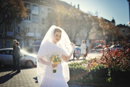 Bride taken veil on autumn sunshineの写真素材