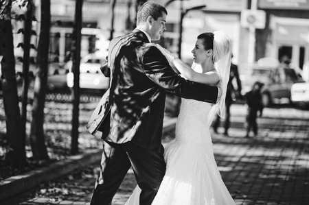 Dancing wedding couple outdoors, black and whiteの写真素材
