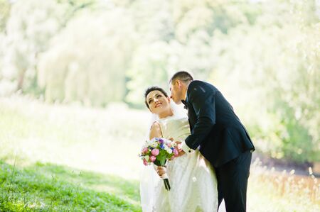 Gorgeus wedding couple on green sunny forestの写真素材