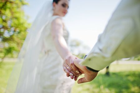 Holding hands of married coupleの写真素材