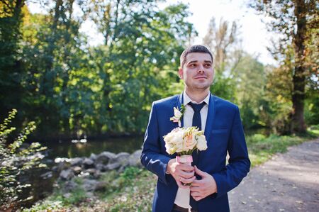 Portrait of groom with bouquetの写真素材