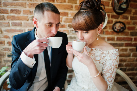 happy and loved wedding couple at the cafeの写真素材
