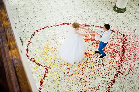first wedding dance of couple in petals of roseの写真素材