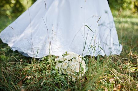 wedding bouquet background white dress of brideの写真素材