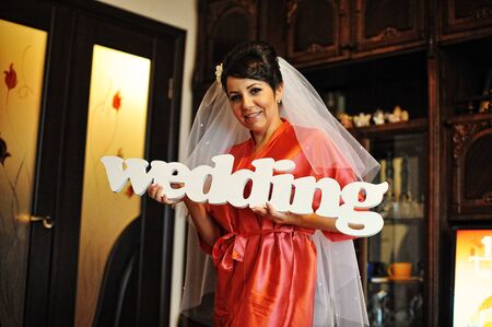 Bride in gown holding a sign weddingの写真素材