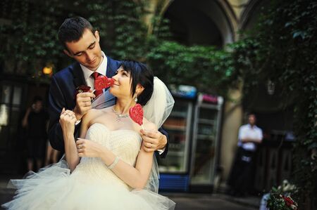 Funny newlyweds with two heart candleの写真素材