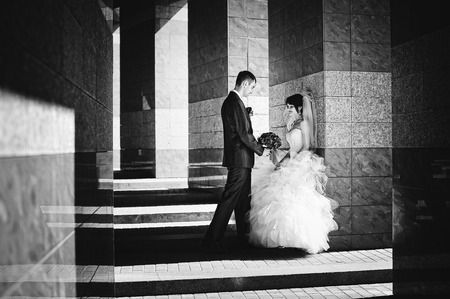 Wedding couple on streets of old city, play with shadowsの写真素材