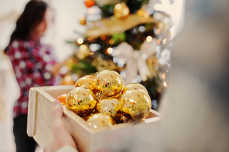 Young stylish girl with Christmas gifts and New Year decoration. Soft warm color tone.の写真素材