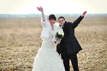 Happy and smiled wedding couple on corn fieldの写真素材