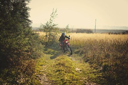 Enduro racer sitting on his motorcycleの写真素材