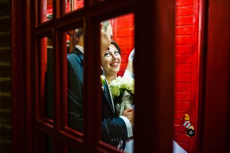 Wedding couple at the phone boothの写真素材