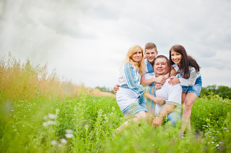 Happy family having fun on field
