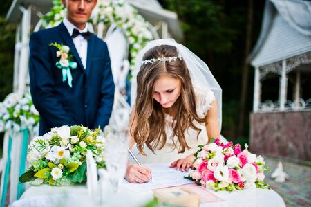 Happy groom and bride on wedding ceremony outdoor