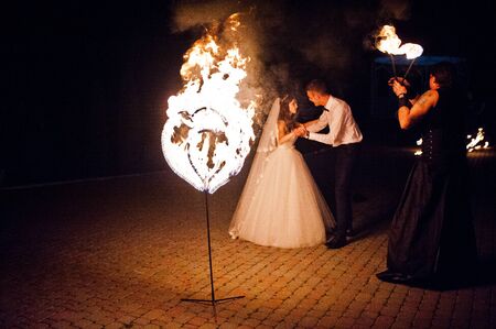 Amazing fire show on wedding ceremony at nightの写真素材