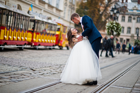 Wedding couple walking on tram waysの写真素材