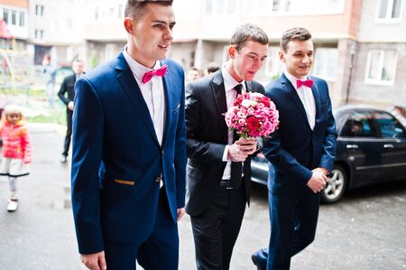 Groom with groomsman background wedding cars