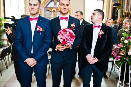 Three stylish groomsman at the churchの写真素材