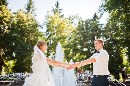 Wedding couple near fountain at sunny dayの写真素材