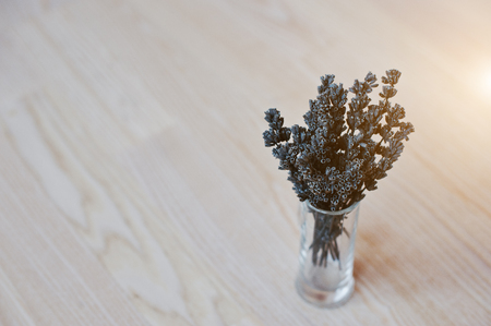 Dried lavender branches at vase at white wooden backgroundの写真素材