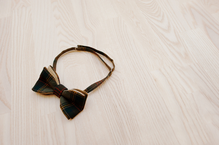 Cotton checkered bow tie on light wooden backgroundの写真素材