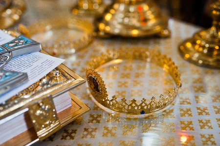Two golden wedding crowns in tetrapods of churchの写真素材