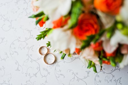 Wedding bouquet with rings on vintage tableの写真素材