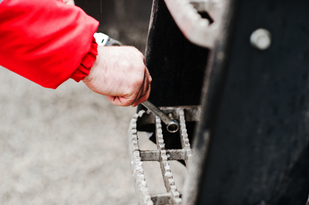 Mechanic hand hold spanner tool in hand at workの写真素材