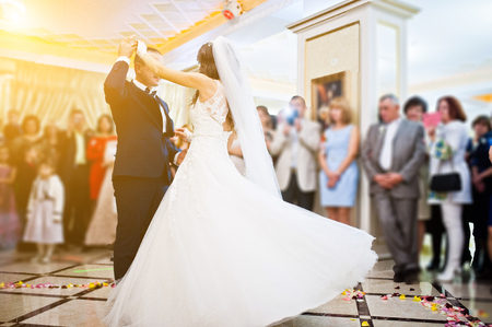 Wonderful wedding newlyweds dancing at the restaurant with lightの写真素材