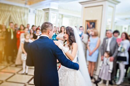 Wonderful wedding newlyweds dancing at the restaurant with lightの写真素材
