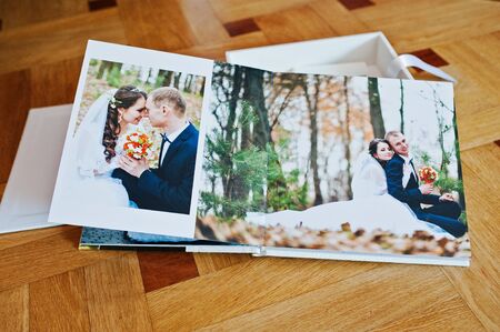 White leather wedding book or wedding album on wooden background