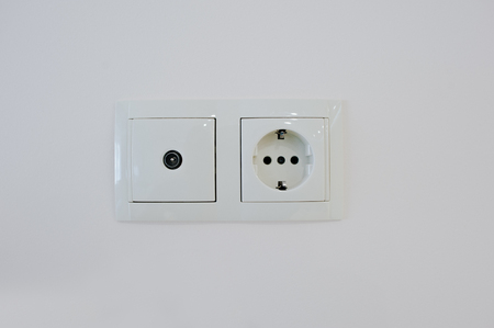 Twin electric socket with tv plug at the wallの写真素材