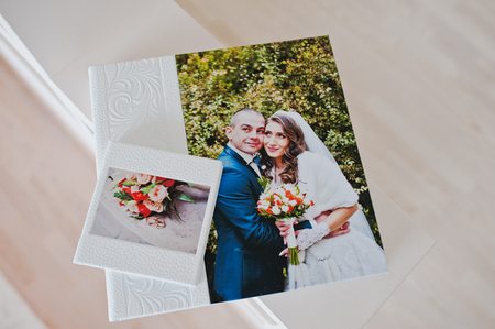 White leather wedding album with photo on canvas of newlywedsの写真素材