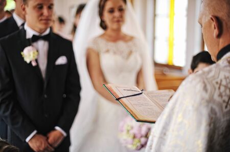 Priest read a holy bible book background newlywedsの写真素材