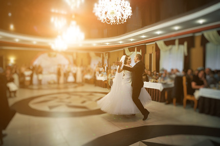 Amazing first wedding dance of stylish wedding couple at luxury restaurantの写真素材