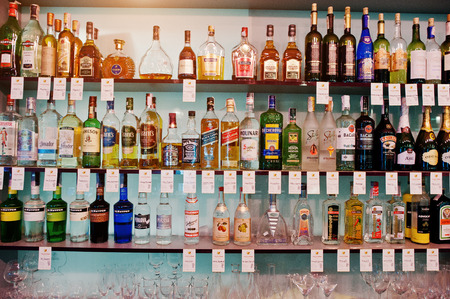 KYIV, UKRAINE - MARCH 25, 2016: Various alcoholic beverages bottles in the bar on the shelf.のeditorial素材