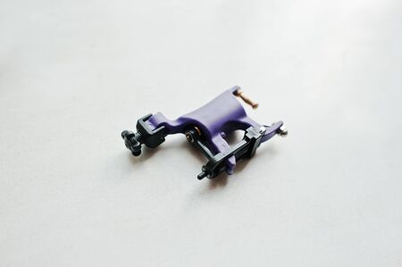 Violet tattoo machine at white background