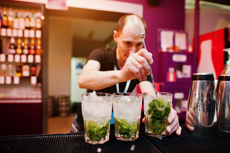 Bartender preparing mojito cocktail drink at the barの写真素材