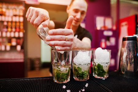 Bartender preparing mojito cocktail drink at the barの写真素材
