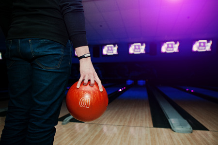 Hand of man player with bracelet holding bowling ballの写真素材