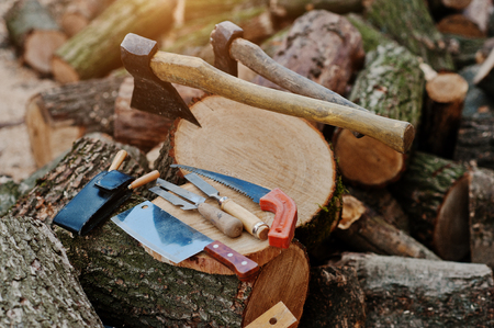 Two axes in stumps with wood working tools background chopped firewood.の写真素材