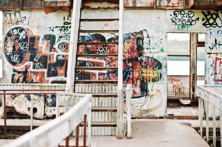 Abandoned metal construction with stairs and various drawings graffitiの写真素材