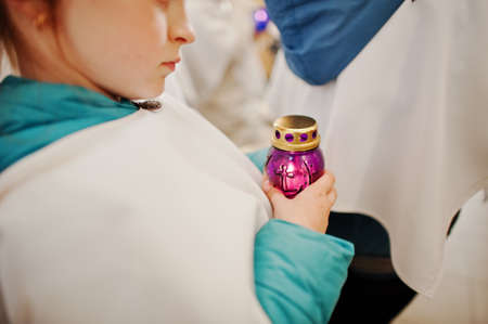LVIV, UKRAINE - APRIL 27, 2016: Holy Week passion and death of Jesus Christ. Children hold candles at churchのeditorial素材