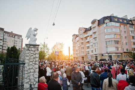 LVIV, UKRAINE - APRIL 27, 2016: Holy Week passion and death of Jesus Christ. Crowd of religious people background angel monumentのeditorial素材