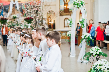 LVIV, UKRAINE - MAY 8, 2016: The ceremony of a First Communion in the Church of St. Peter the Great...